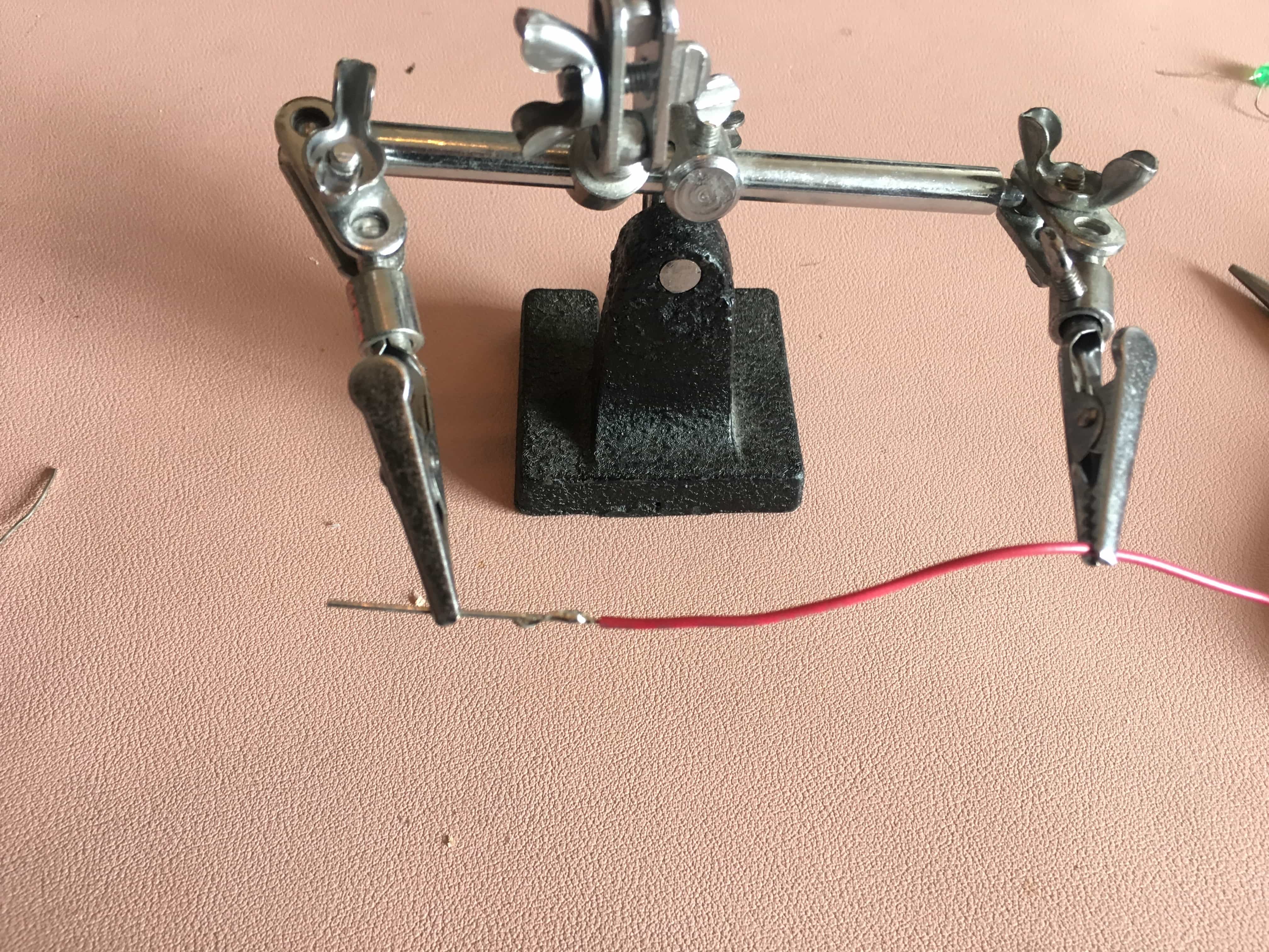 Metal rod soldered to red wire