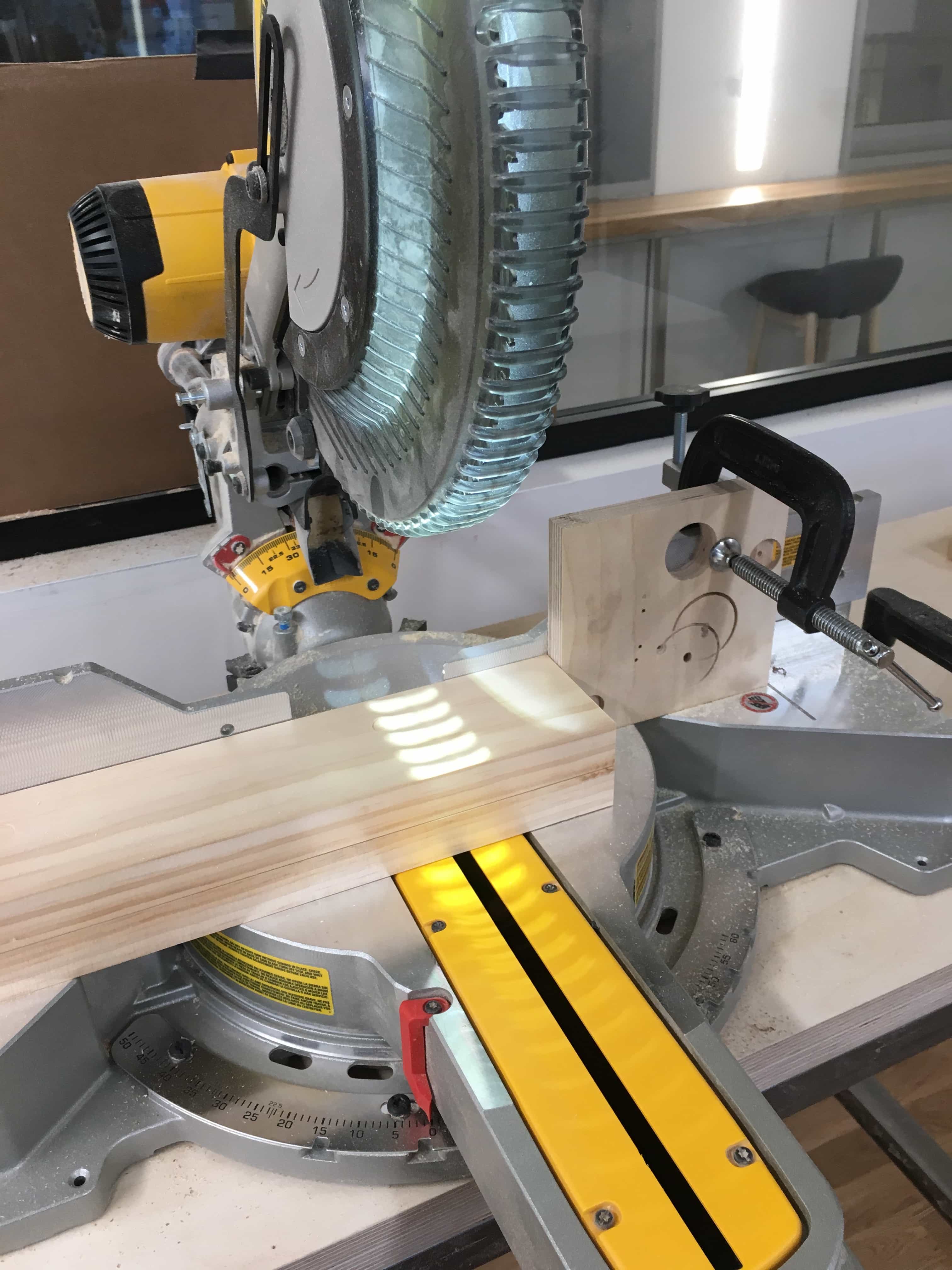 Miter saw with wood ready to cut.