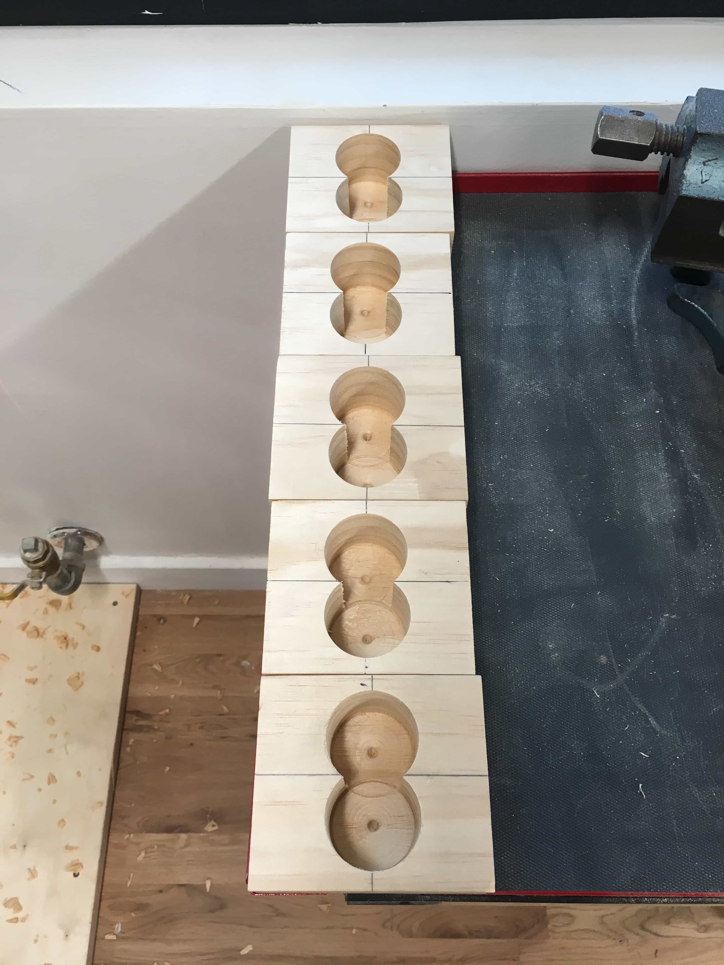 Five blocks with holes drilled into them.