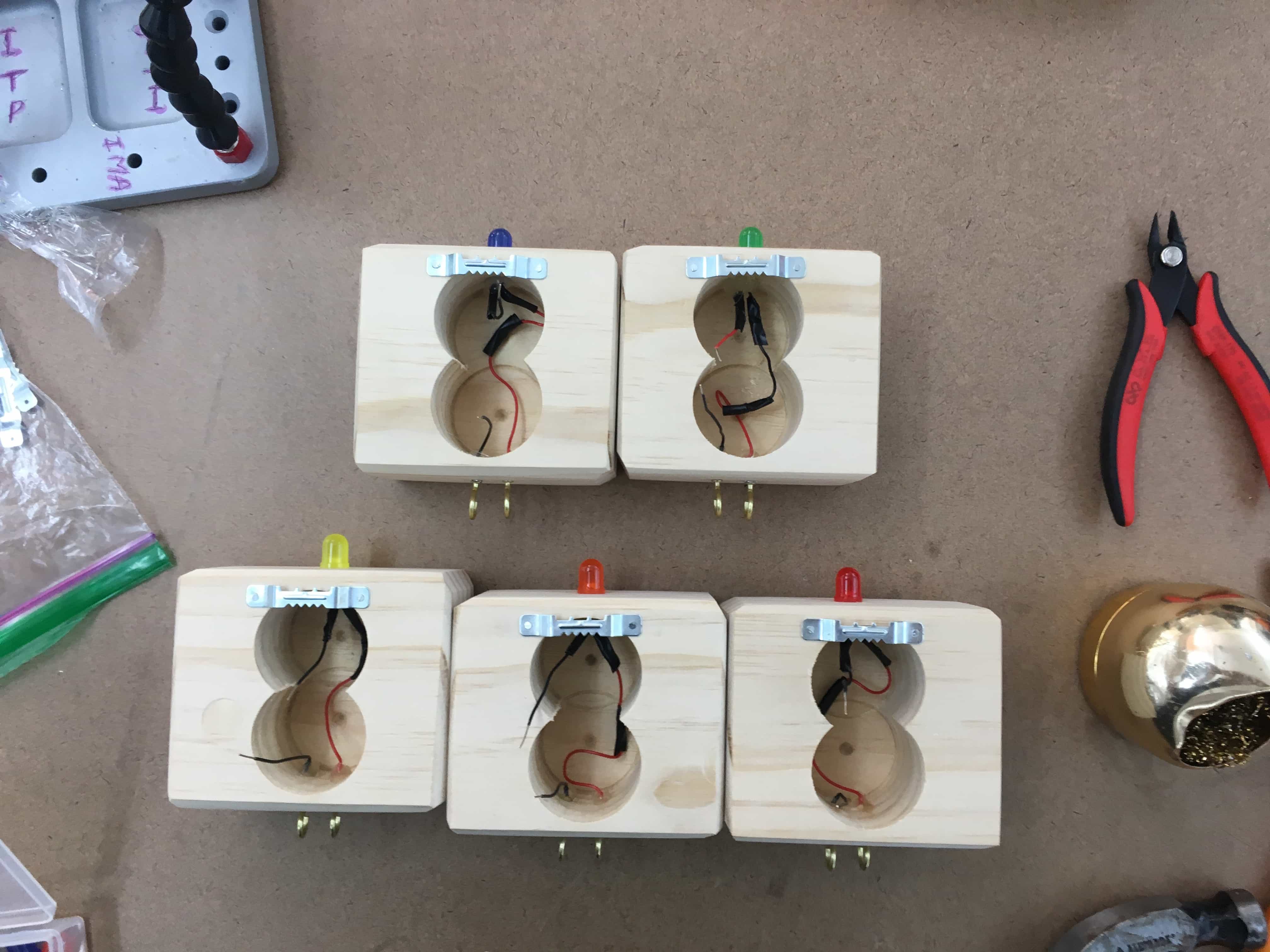 5 boxes with wall hooks attached.